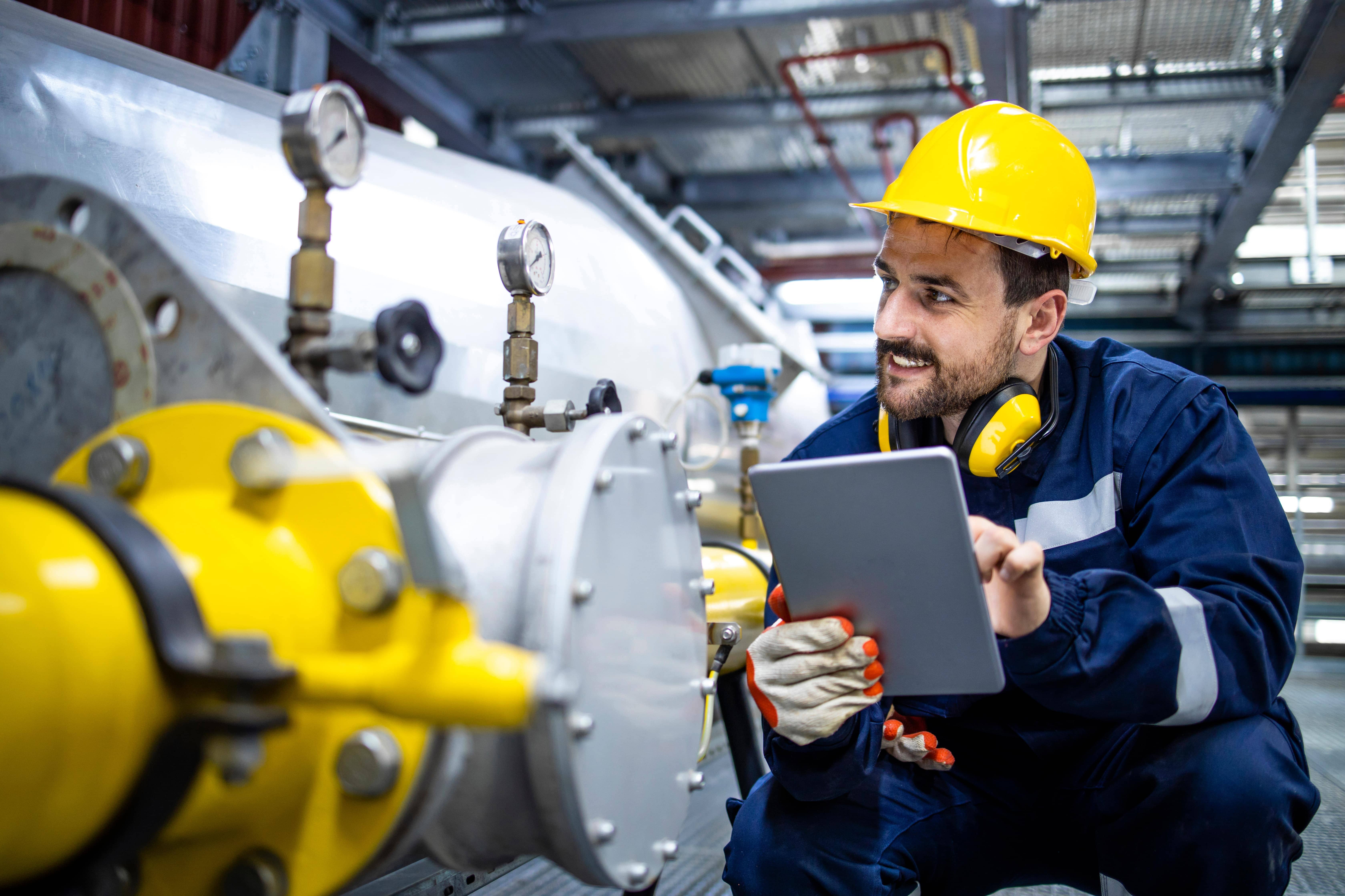 Technician inspecting a commercial LPG cylinder manifold